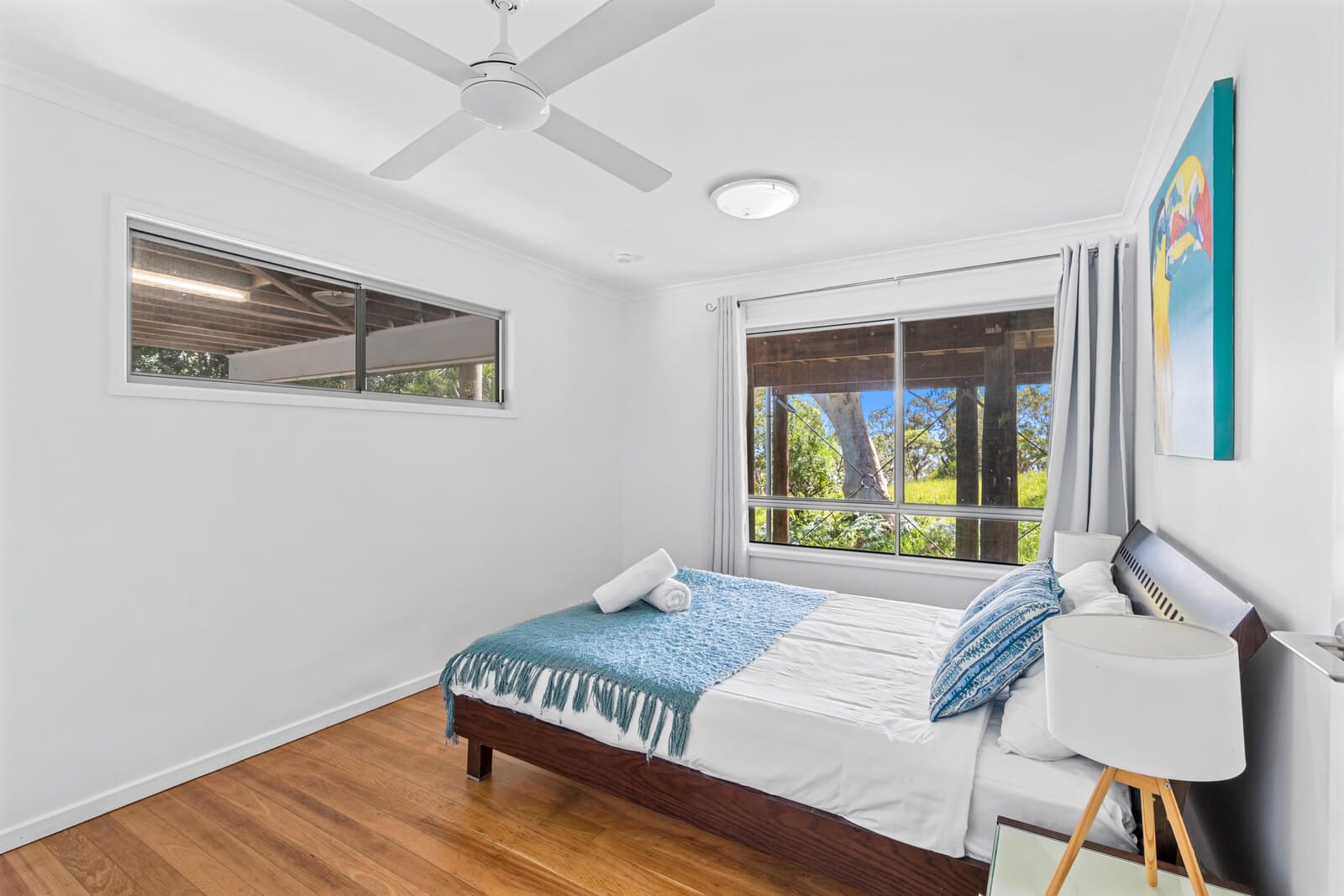 Bright bedroom with white linen and bedside lamps