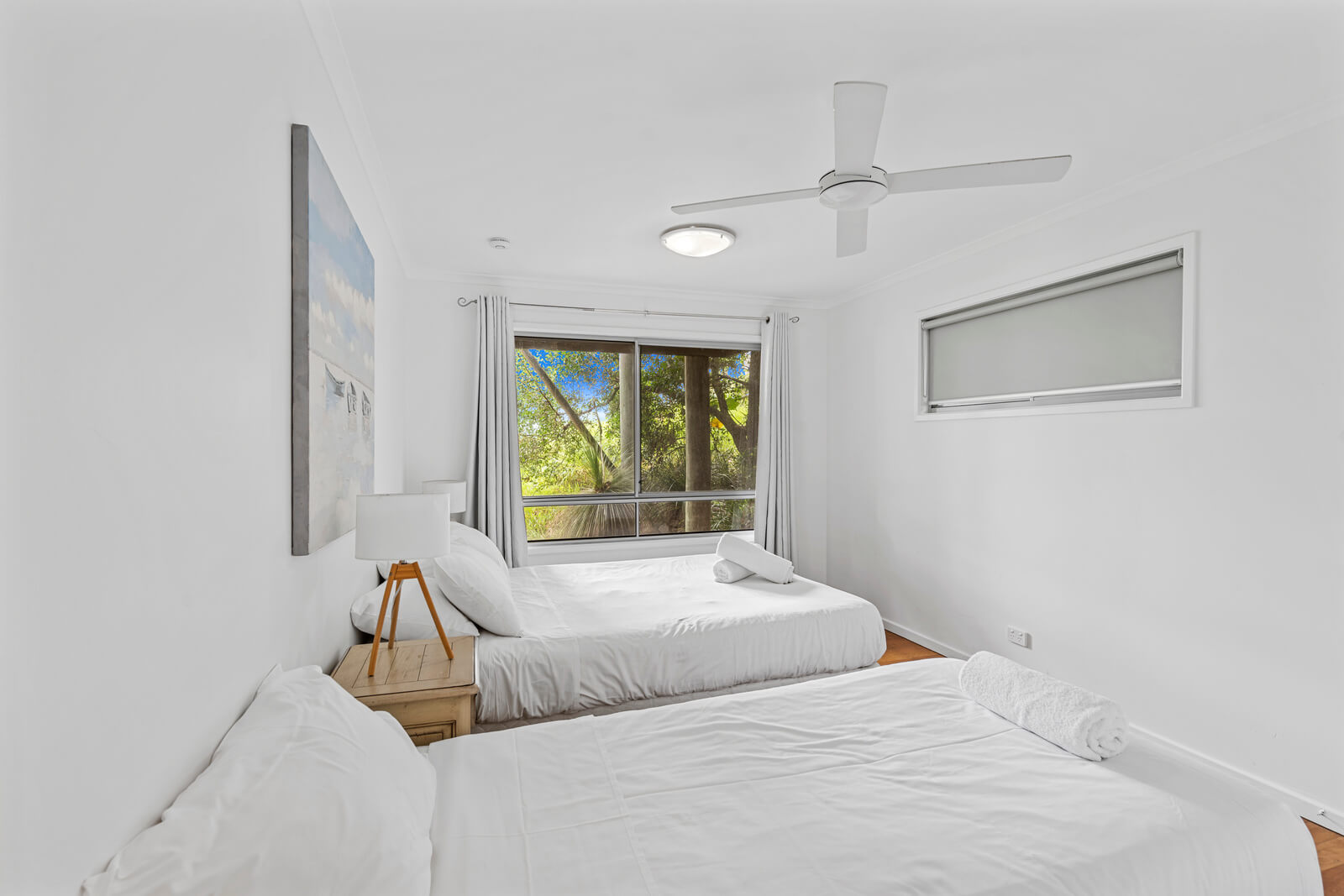 Twin bedroom with simple décor and window outlook