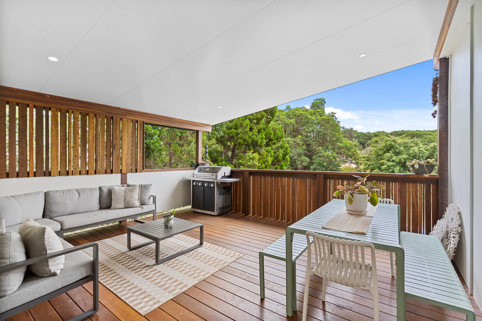 Balcony area with chairs for outdoor relaxation and griller