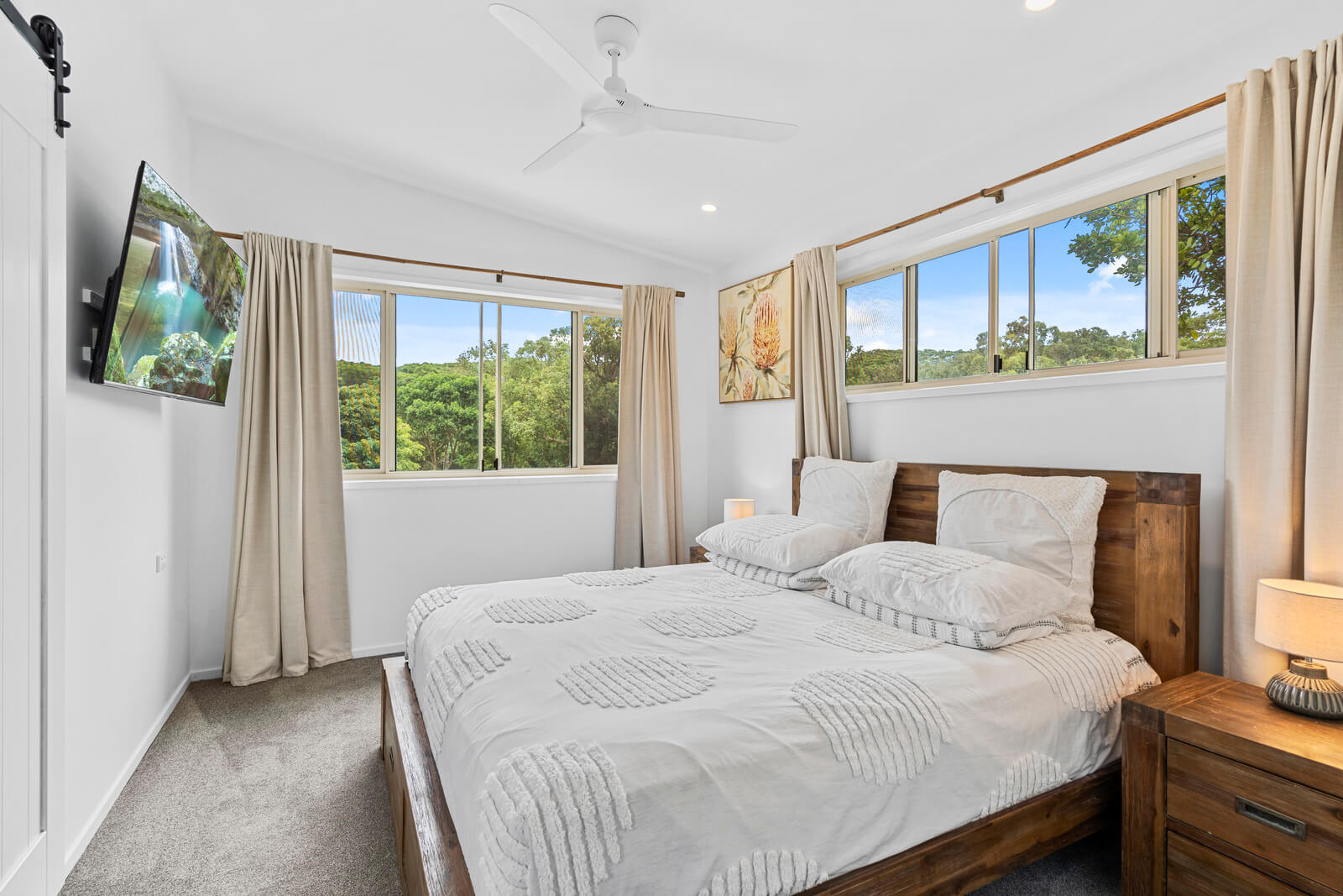 Bright bedroom with wide windows with coastal view