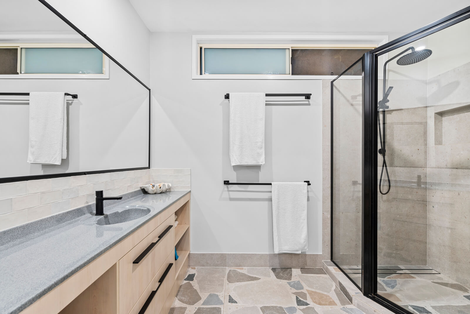 Spacious bathroom with practical layout and natural light