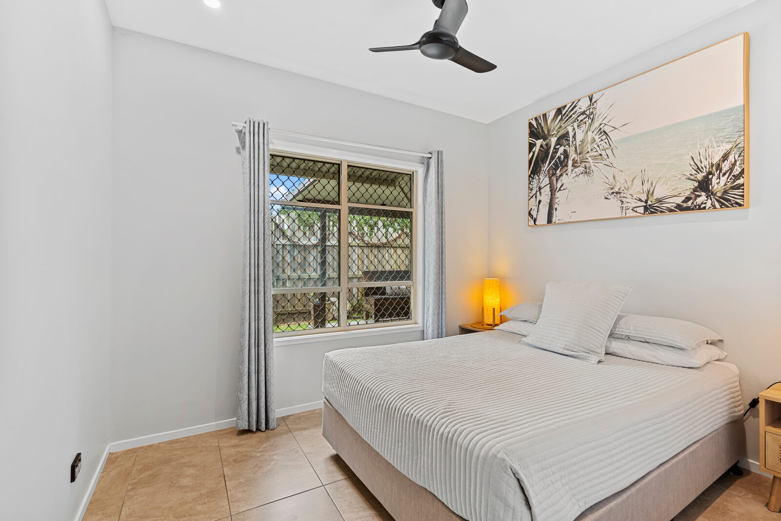 Bedroom with ocean breeze windows and neutral décor