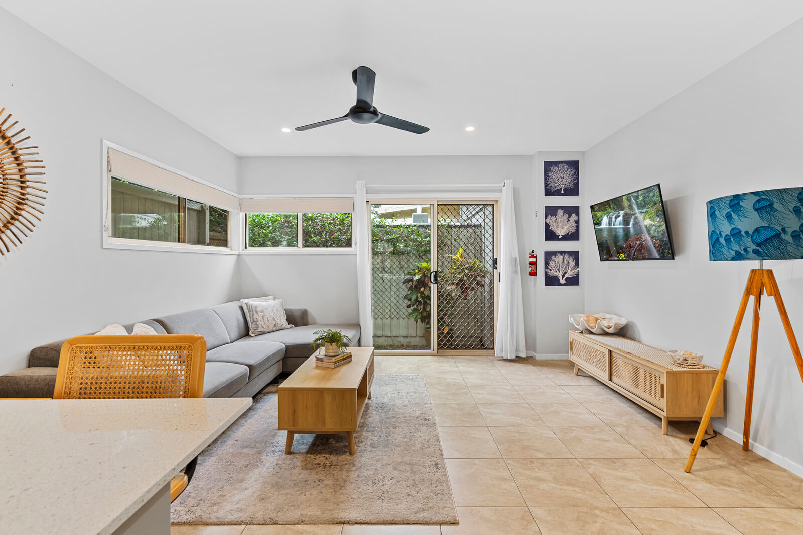 Comfortable living space with sofa, dining area and fan