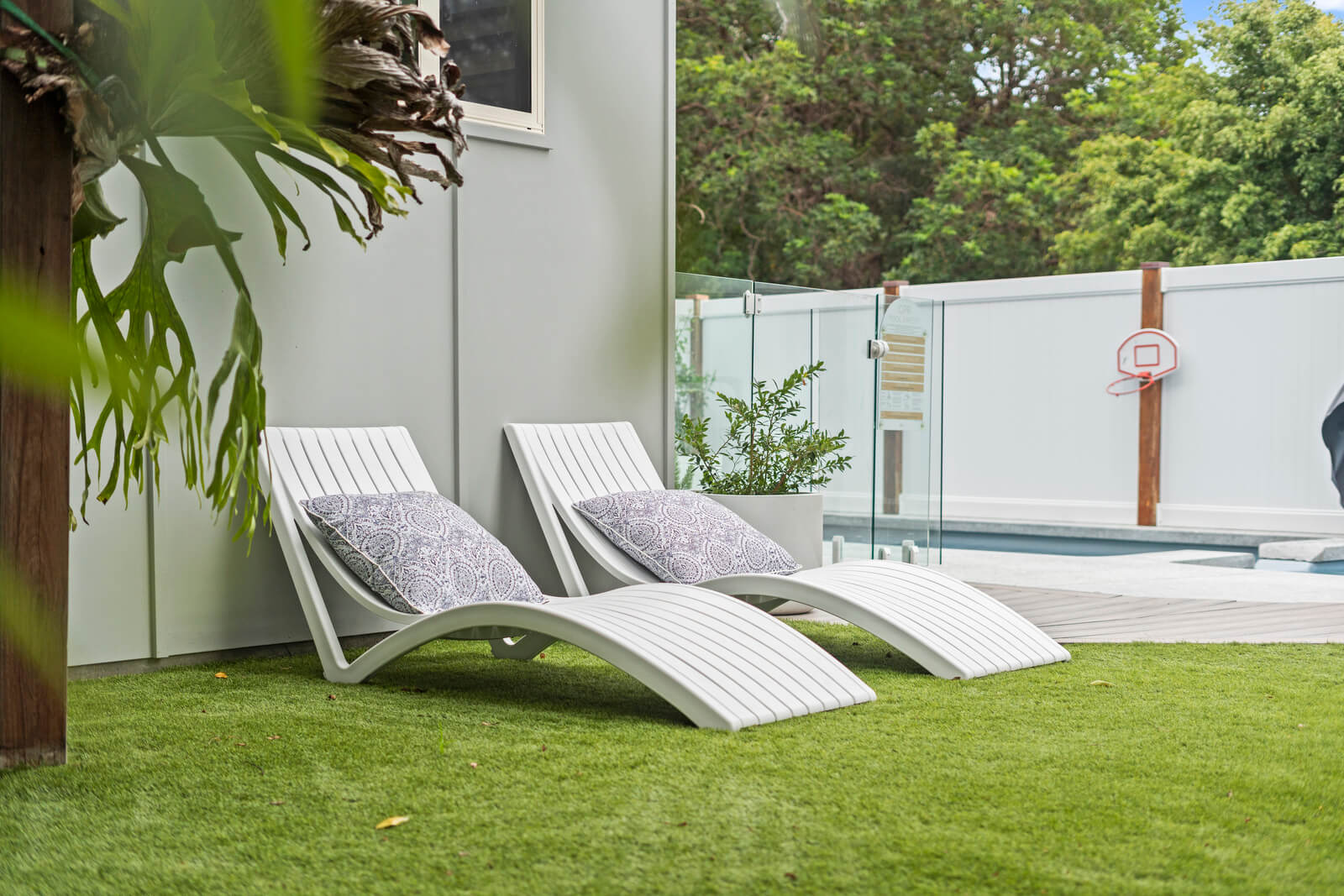 Poolside area with seating and tropical greenery